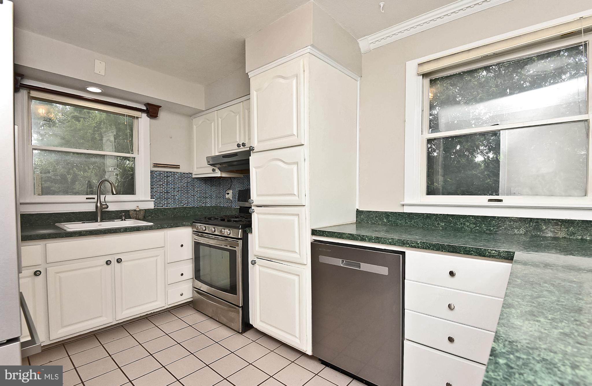 15 Constance Drive Hamilton, NJ 08620 - Photo 9 of 29 a kitchen with granite countertop white cabinets and white appliances