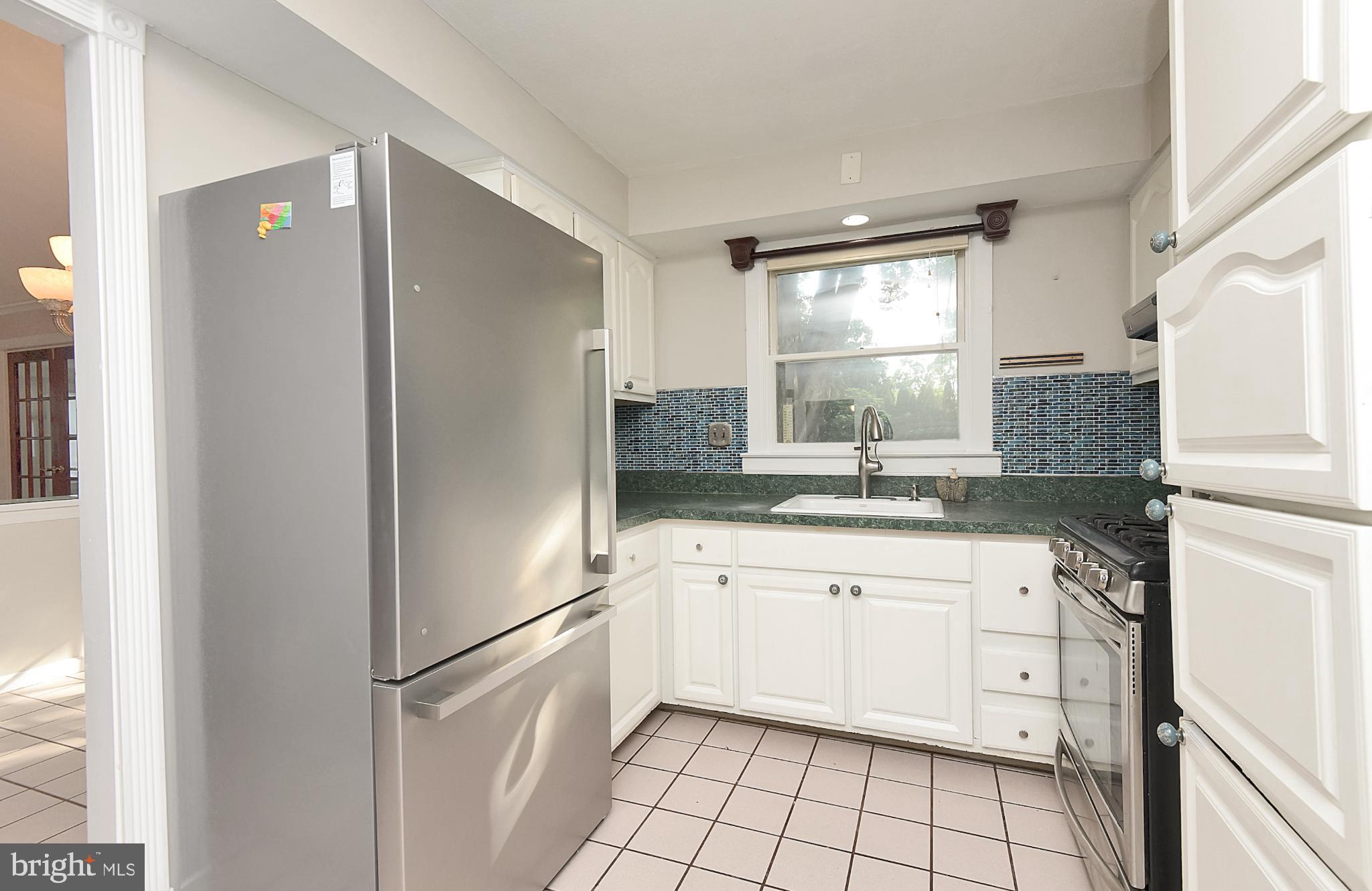15 Constance Drive Hamilton, NJ 08620 - Photo 10 of 29 a kitchen with white cabinets and white appliances