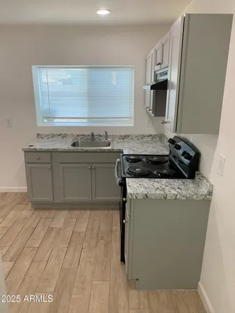 a kitchen with stainless steel appliances granite countertop a stove and a sink