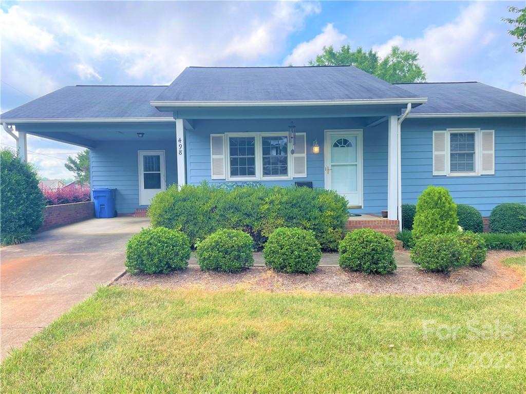498 Whiteside Road Rutherfordton, NC 28139 - Photo 3 of 19 a view of a house with a garden and plants