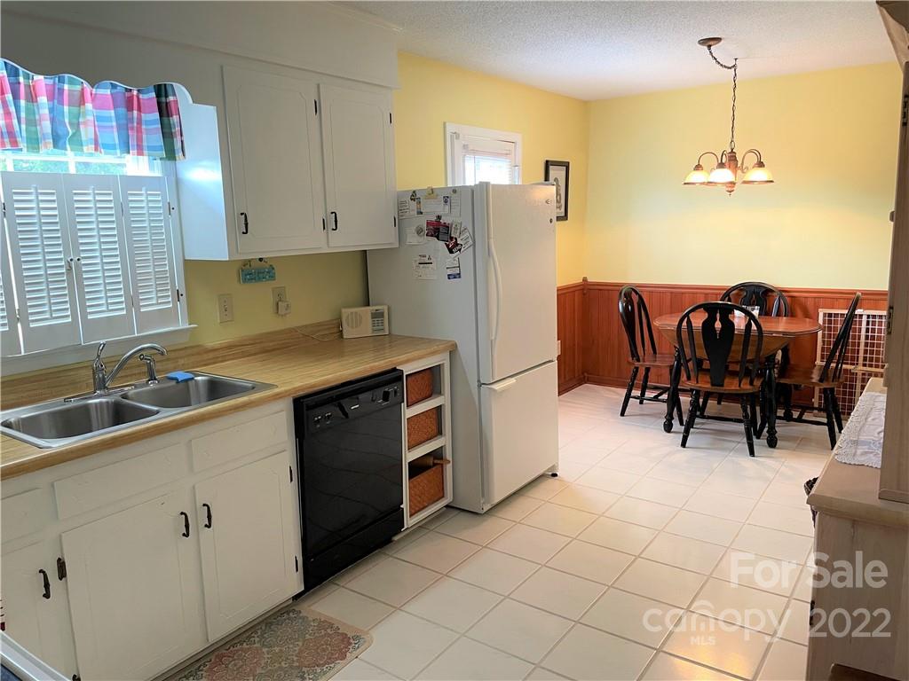 498 Whiteside Road Rutherfordton, NC 28139 - Photo 4 of 19 a kitchen with refrigerator and cabinets