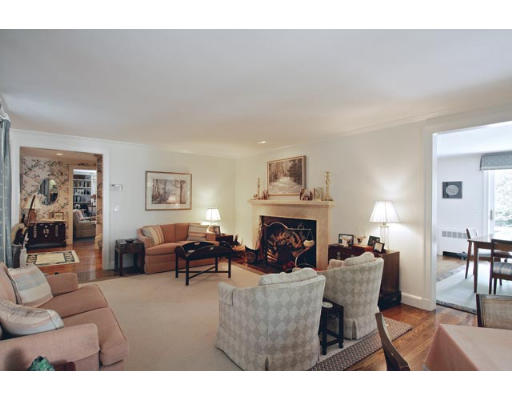 143 Fairway Road Brookline, MA 02467 - Photo 3 of 4 a living room with furniture a fireplace and a table