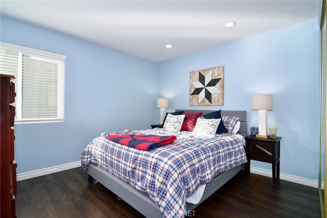 a bedroom with a bed and a lamp