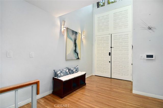 a view of a room with wooden floor and cabinet