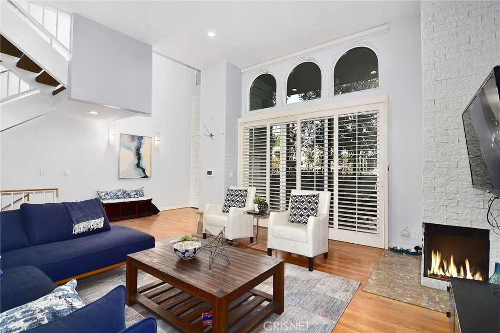 5305 White Oak Avenue, Unit E Encino, CA 91316 - Photo 4 of 26 a living room with furniture a fireplace and a flat screen tv