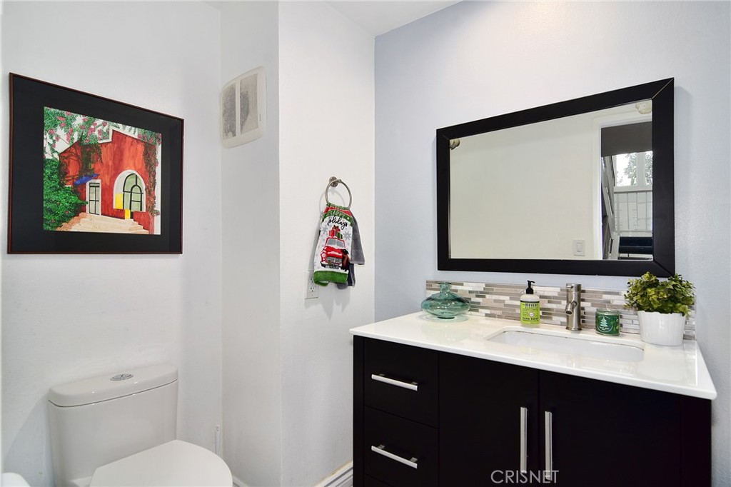 5305 White Oak Avenue, Unit E Encino, CA 91316 - Photo 10 of 26 a bathroom with a toilet a sink and a mirror