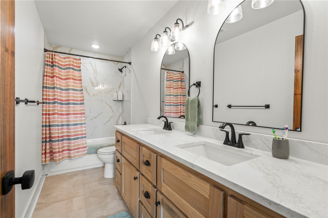 16556 East Hewitt Springs Road Springdale, AR 72764 - Photo 36 of 60 Double vanity with undermount sinks and light wood-finish cabinetry
