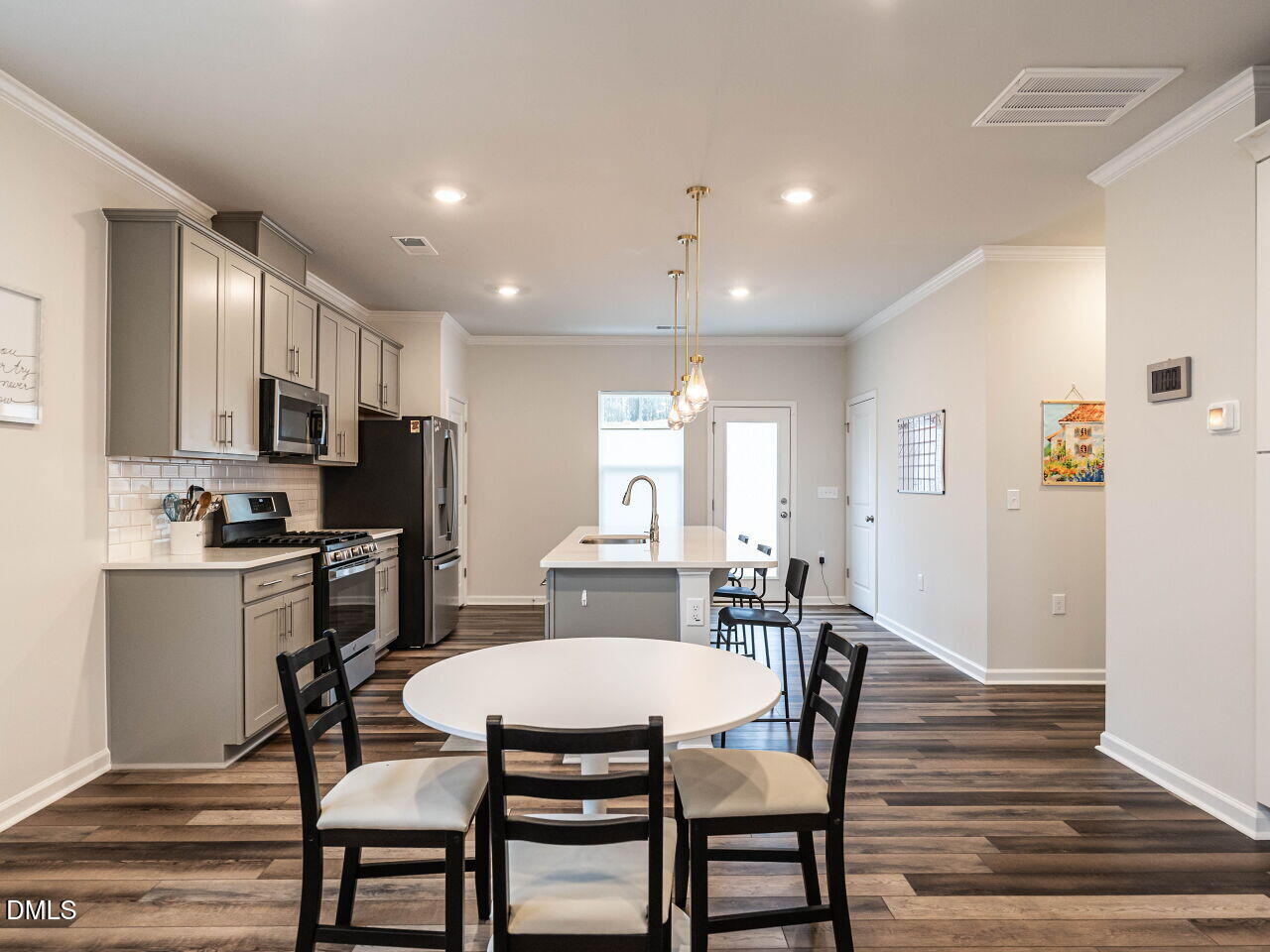 2456 Tonoloway Drive Raleigh, NC 27610 - Photo 11 of 45 a view of a dining room with furniture a kitchen and chandelier