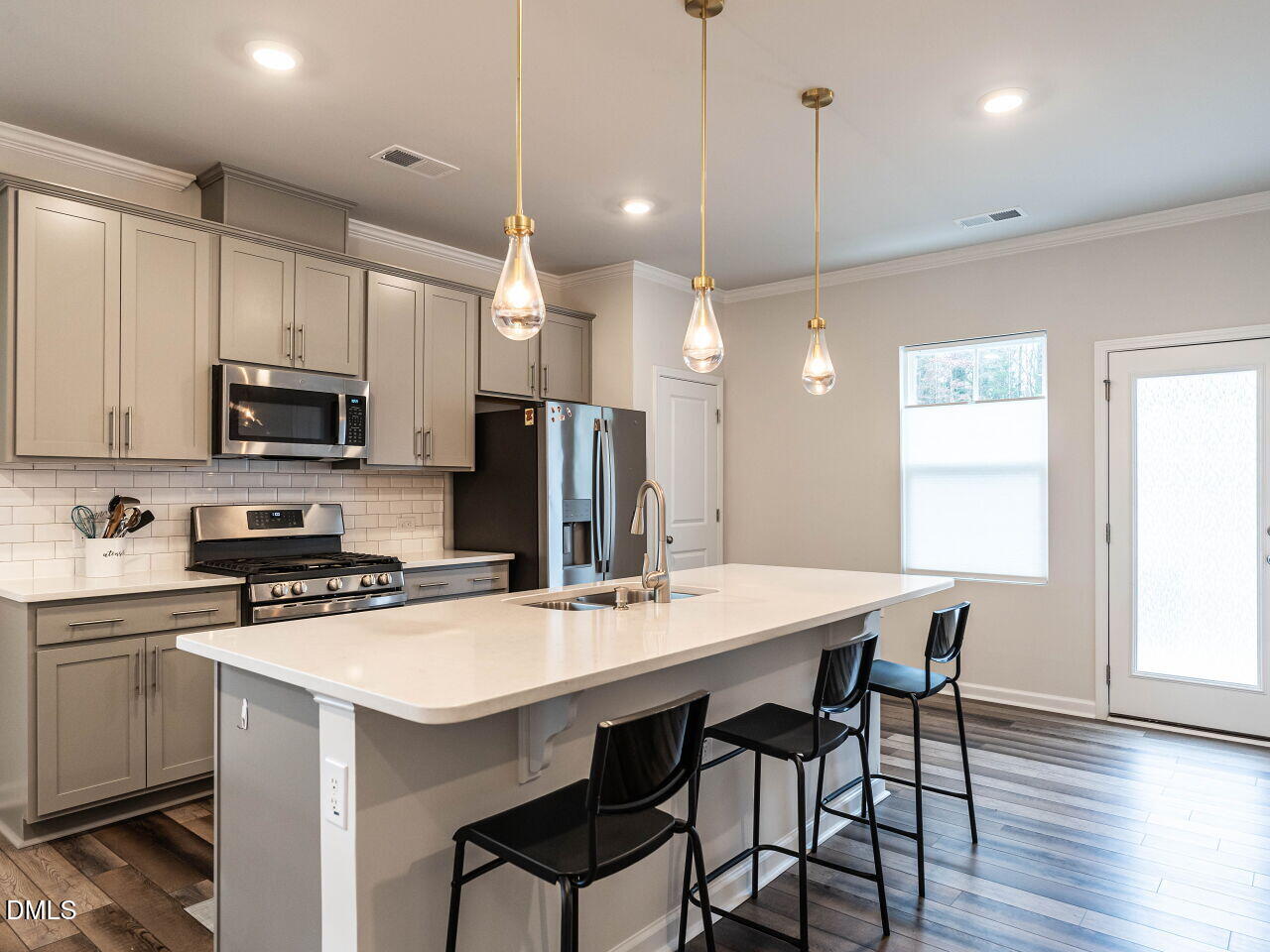 2456 Tonoloway Drive Raleigh, NC 27610 - Photo 15 of 45 a kitchen with a dining table chairs sink and microwave
