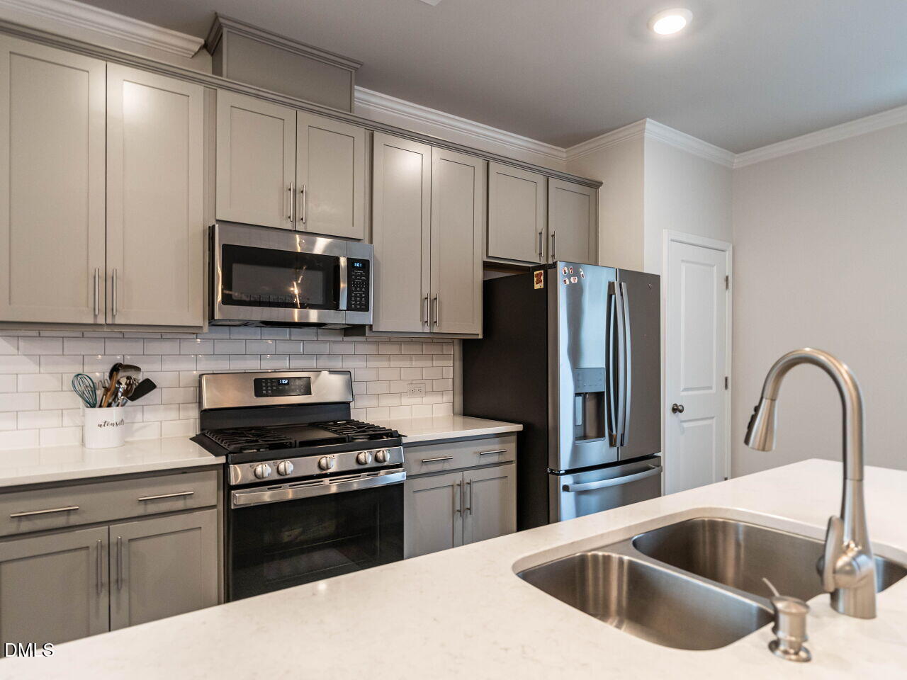 2456 Tonoloway Drive Raleigh, NC 27610 - Photo 19 of 45 a kitchen with a sink cabinets and stainless steel appliances