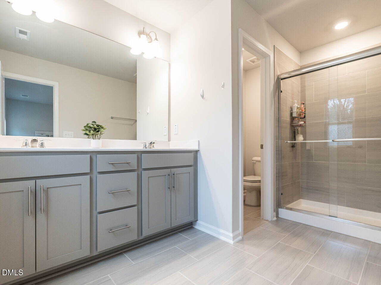 2456 Tonoloway Drive Raleigh, NC 27610 - Photo 25 of 45 a bathroom with a double vanity sink and a mirror