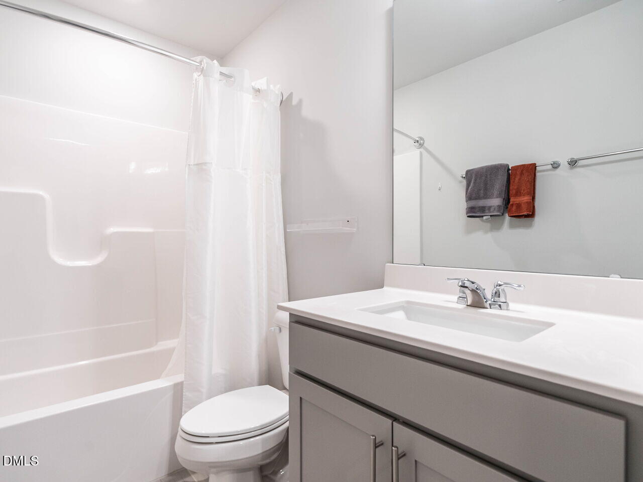 2456 Tonoloway Drive Raleigh, NC 27610 - Photo 29 of 45 a bathroom with a sink a toilet and a mirror