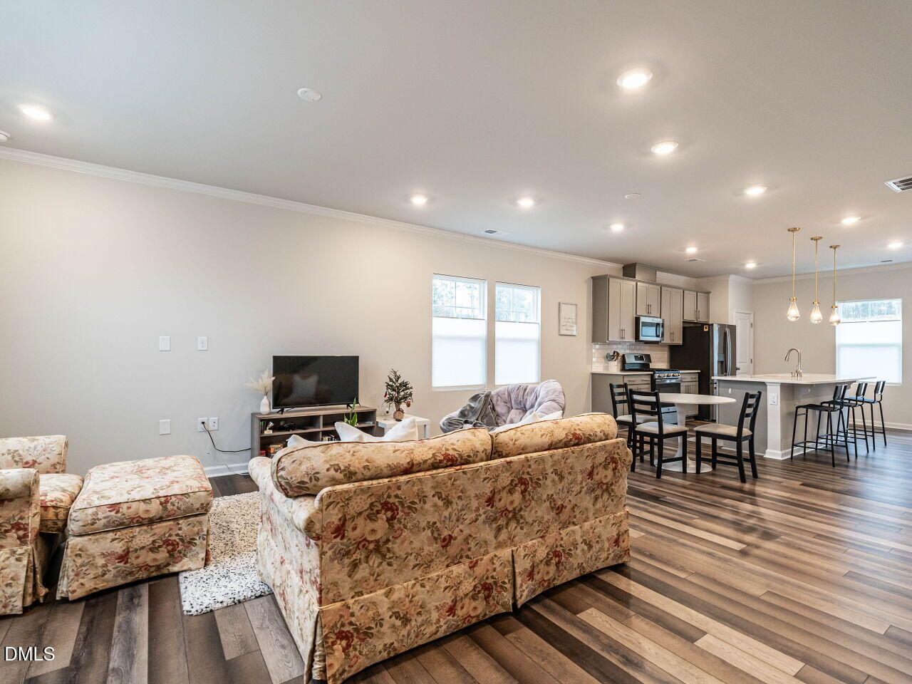 2456 Tonoloway Drive Raleigh, NC 27610 - Photo 6 of 45 a living room with furniture and a flat screen tv