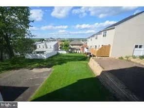 a view of a backyard with sitting area