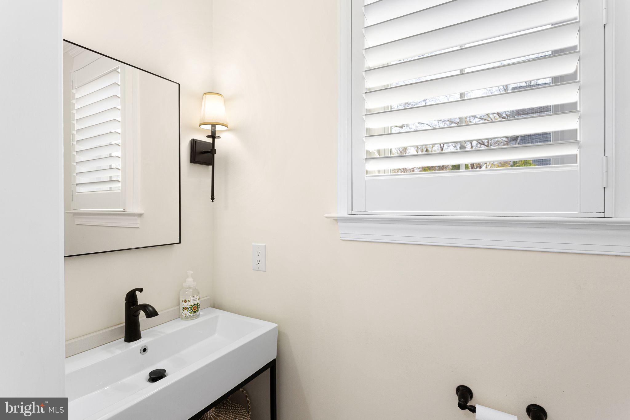 305 Grove Street Haddonfield, NJ 08033 - Photo 17 of 45 a bathroom with a sink and a mirror