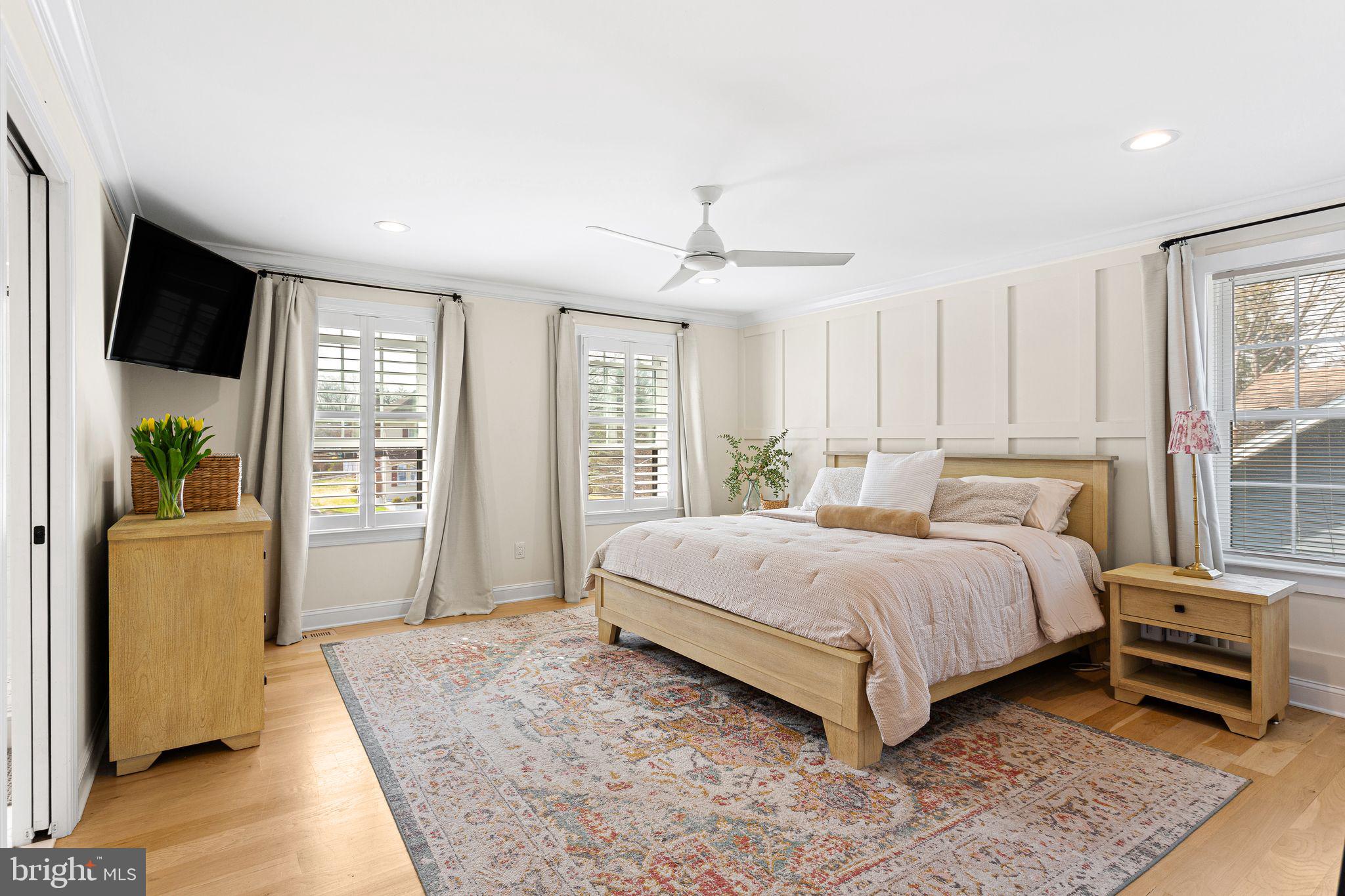 305 Grove Street Haddonfield, NJ 08033 - Photo 18 of 45 a bedroom with a large bed and a flat tv screen
