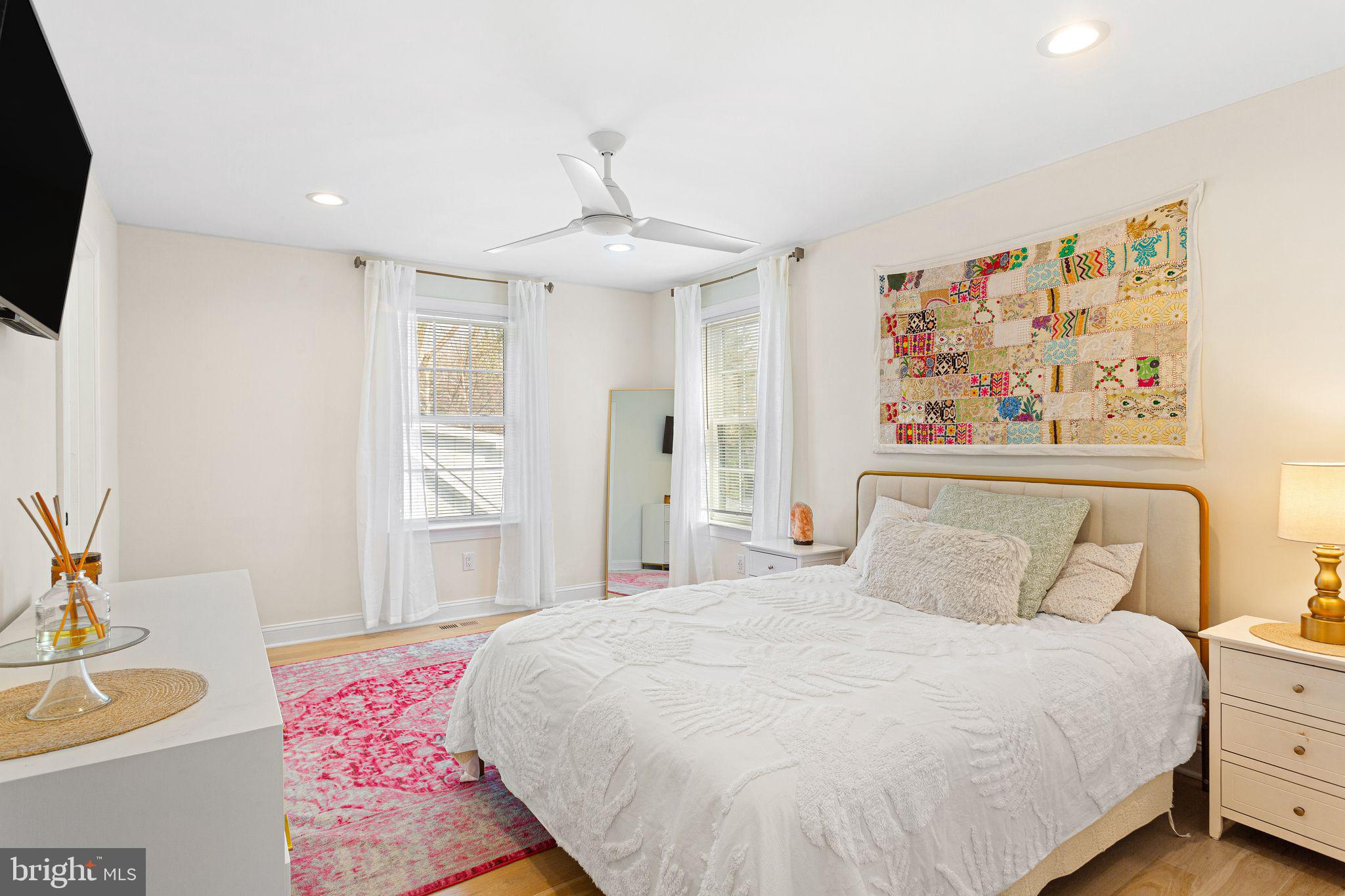 305 Grove Street Haddonfield, NJ 08033 - Photo 27 of 45 a bedroom with a bed and a chandelier