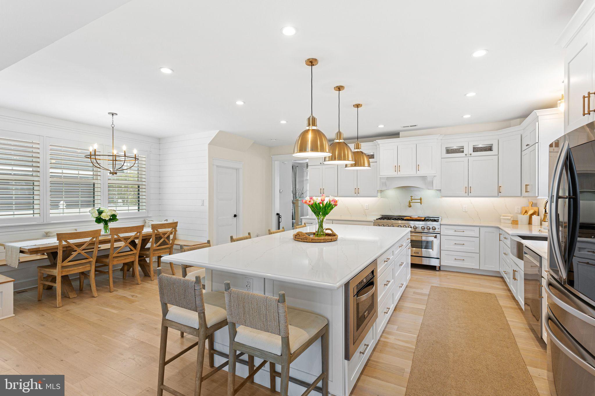 305 Grove Street Haddonfield, NJ 08033 - Photo 3 of 45 a large kitchen with kitchen island a dining table and chairs