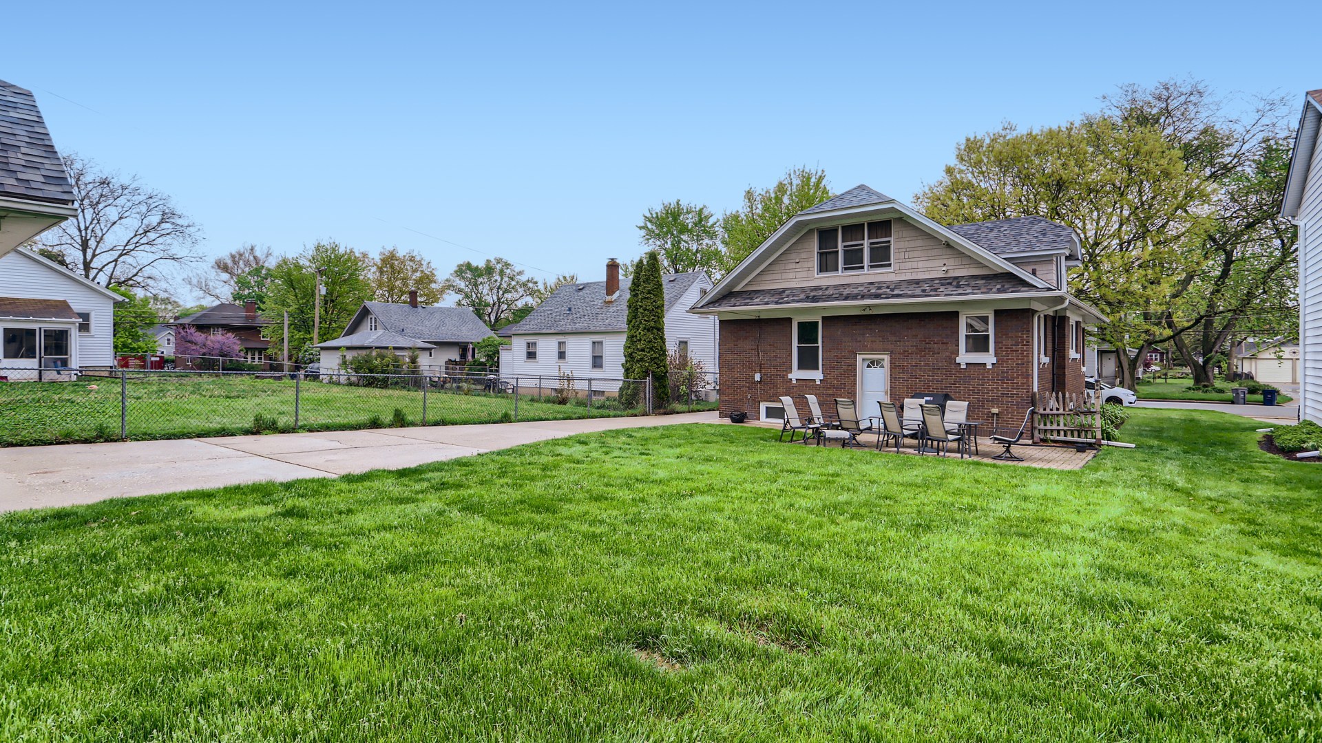 940 Logan Avenue Elgin, IL 60120 - Photo 16 of 16 a front view of a house with a garden and trees