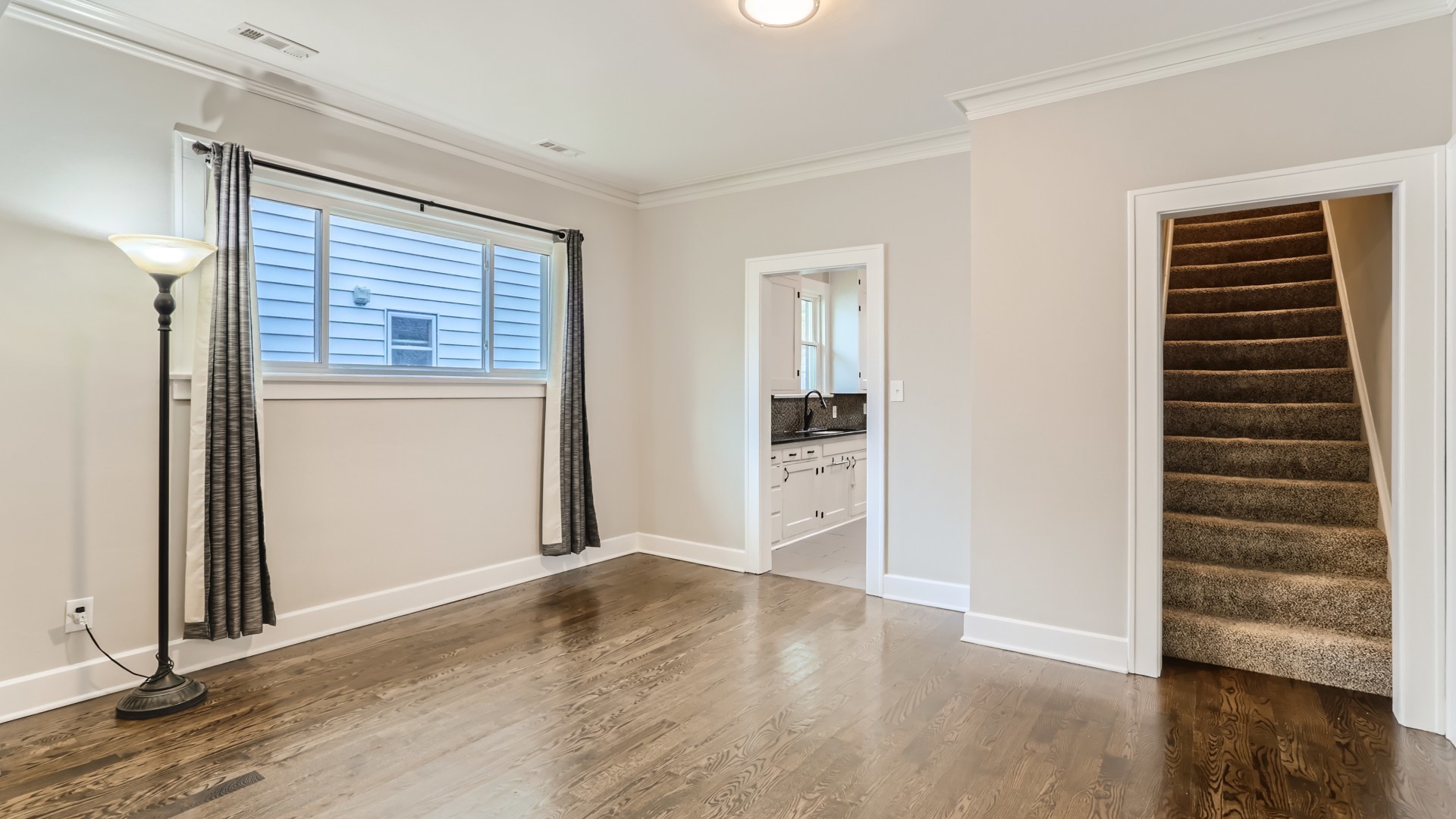 940 Logan Avenue Elgin, IL 60120 - Photo 5 of 16 an empty room with wooden floor closet and windows