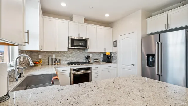 a kitchen with stainless steel appliances a refrigerator and a sink