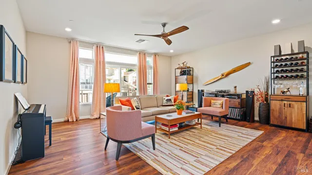 a living room with furniture a rug and a large window