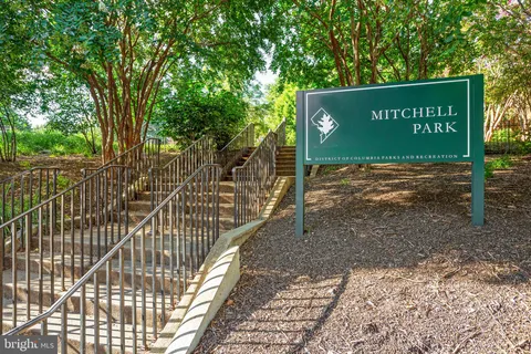 a view of a street with benches in the background