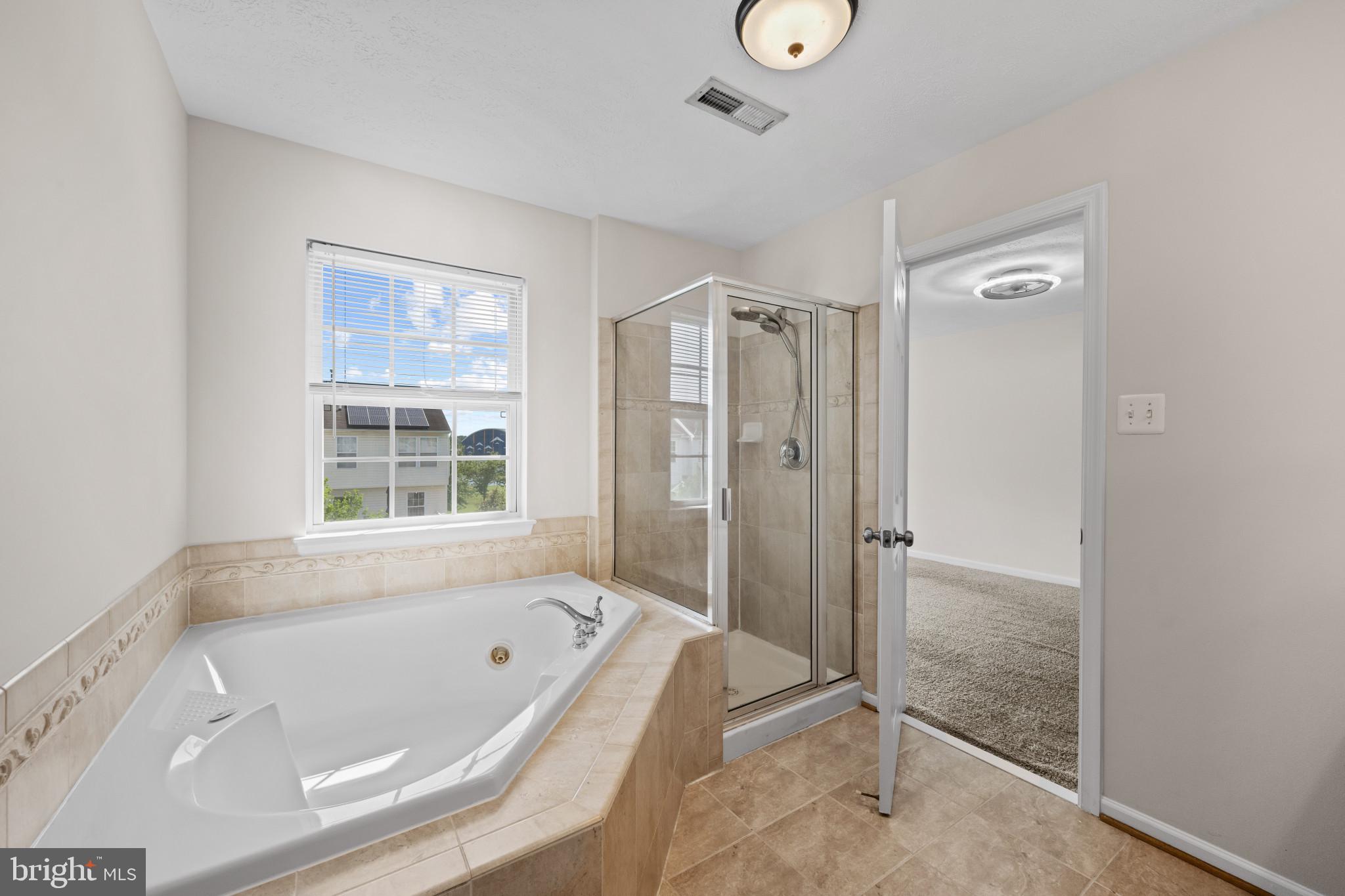9853 Decatur Road Middle River, MD 21220 - Photo 23 of 37 Bathroom featuring a corner soaking tub with tile