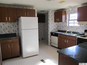 135 Reading Road Salisbury, NC 28147 - Photo 4 of 6 a kitchen with a refrigerator and a stove