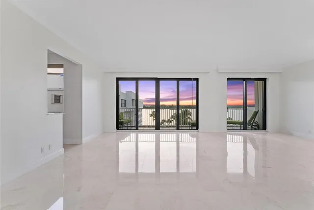 wooden floor chandelier and windows in a room
