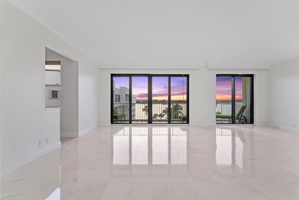 wooden floor chandelier and windows in a room