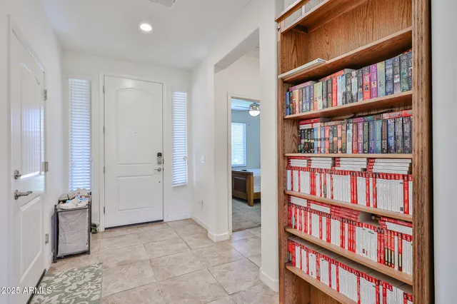 a view of room with windows book shelf