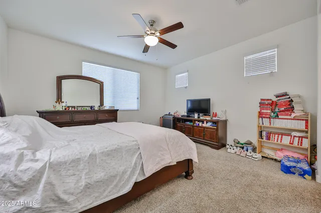 a bedroom with a bed and a chandelier