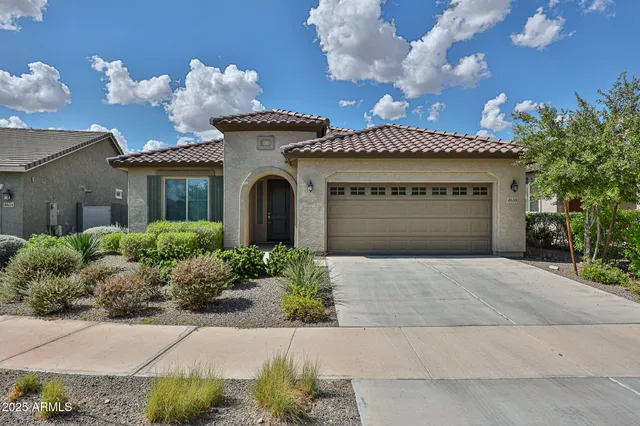 a front view of a house with a yard and a garage