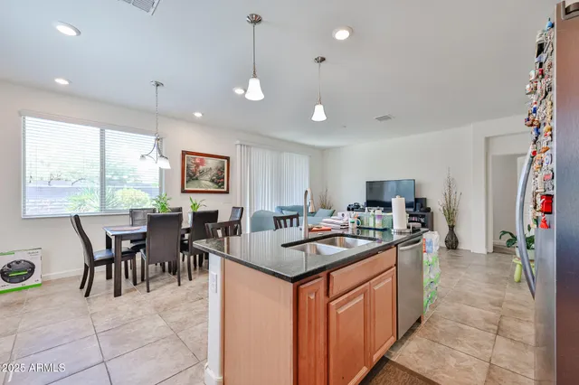 a kitchen with a counter top space appliances and a dining table