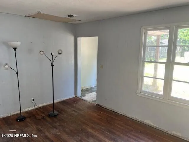 a view of a room with wooden floor and window