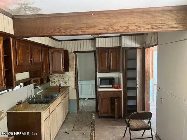 a kitchen that has a sink and a stove top oven
