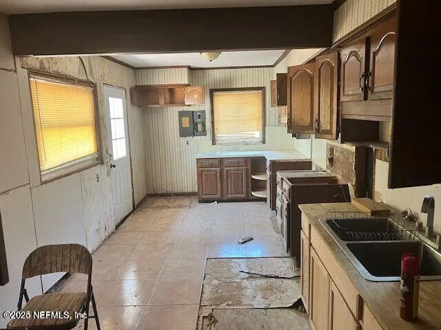 a kitchen with a stove a sink and a refrigerator