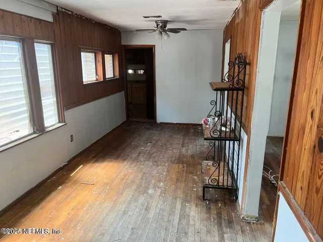 a view of entryway and hall with wooden floor