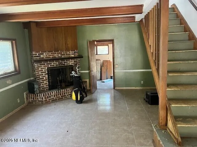 a view of a livingroom with furniture and staircase