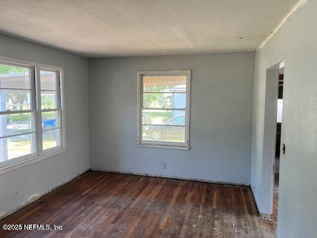 3768 Valley Road Jacksonville, FL 32207 - Photo 9 of 29 an empty room with wooden floor and windows
