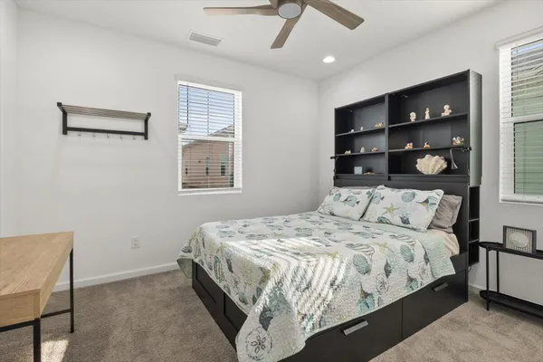 a bedroom with a bed and window