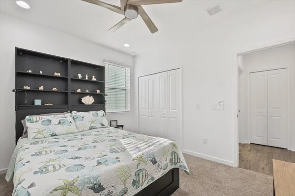 a bedroom with a large bed and a window