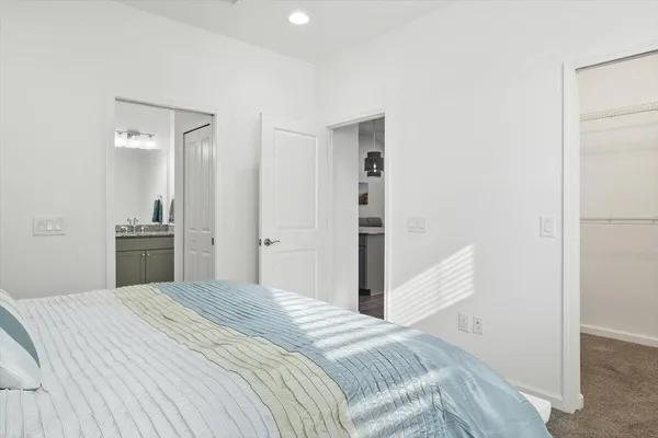 a bedroom with a bed and cabinets
