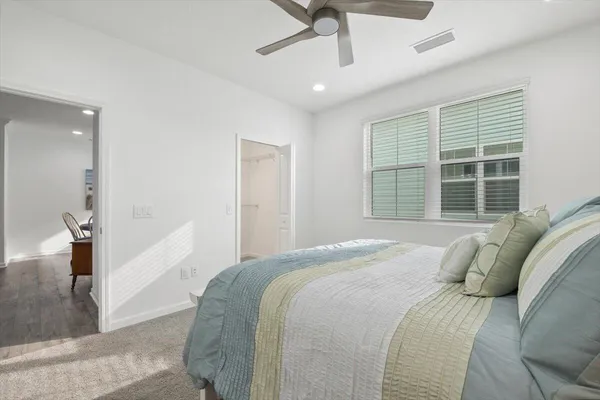 a bedroom with a bed and a large window