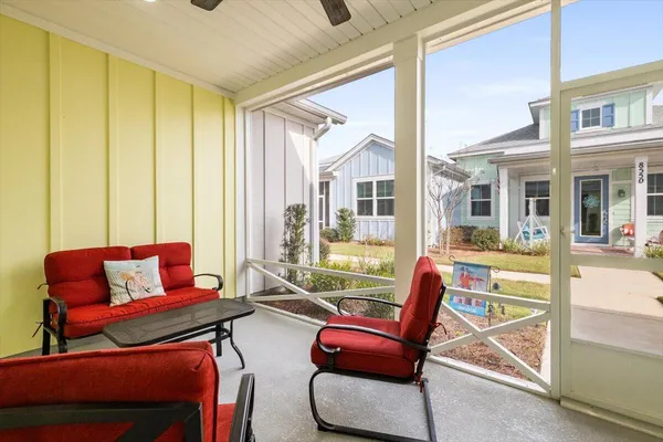 a living room with furniture a floor to ceiling window and a flat screen tv