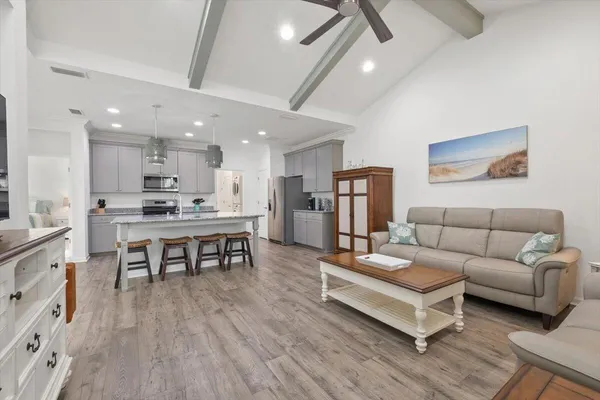 a living room with furniture and kitchen view