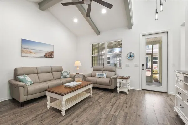 a living room with furniture and wooden floor