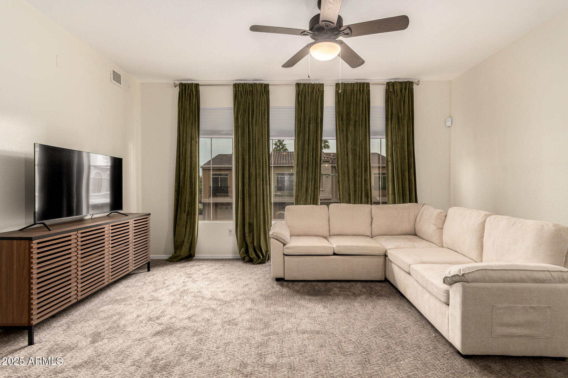 240 West Juniper Avenue, Unit 1010 Gilbert, AZ 85233 - Photo 12 of 46 a living room with furniture and a flat screen tv