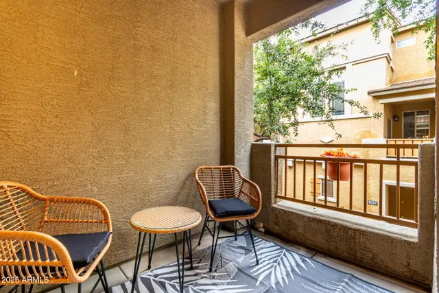a view of a chair and table in the balcony